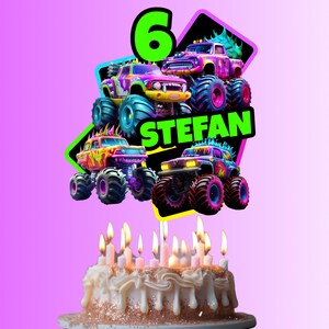 以下が含まれることがあります： モンスタートラックをテーマにしたケーキトッパーが付いた誕生日ケーキ。トッパーには、さまざまな色のモンスタートラックが4台、緑色の数字6、そして「STEFAN」という名前が書かれています。