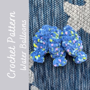 May include: Three crocheted blue and white water balloons with a light blue, pink, and yellow speckled pattern. The crochet pattern is called "Crochet Pattern Water Balloons".