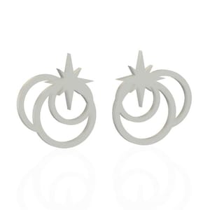 May include: A pair of silver-colored stud earrings. Each earring features a star design atop two connected, curved shapes. The earrings are displayed on a white background, with a subtle reflection visible below.