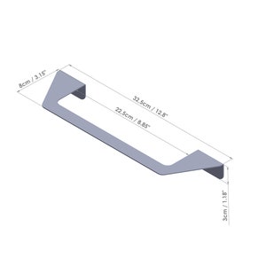 May include: Silver metal cabinet handle with a rectangular shape and rounded edges. The handle measures 12.8 inches long, 8.85 inches wide, and 1.18 inches high.