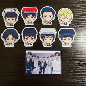 Puede incluir: Nueve pegatinas de dibujos animados de hombres jóvenes con diferentes peinados y ropa. Las pegatinas están sobre una superficie de madera. Debajo de las pegatinas hay una foto de siete hombres jóvenes en una banda.