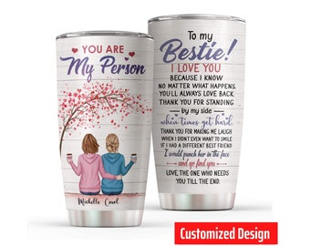 May include: A stainless steel tumbler with a white background and a pink and purple design. The tumbler features a quote about friendship and the text "To my Bestie! I love you". The tumbler also has the text "Michelle Carol" at the bottom.
