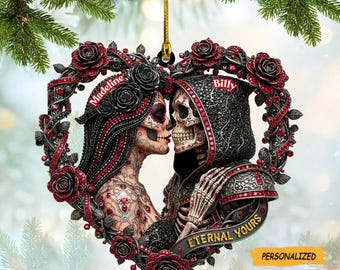 May include: Heart-shaped ornament featuring a kissing skeleton couple, adorned with red roses and intricate details. The ornament includes the names "Madeline" and "Billy", with the phrase "Eternal Yours" on a banner. The word "PERSONALIZED" is also visible.