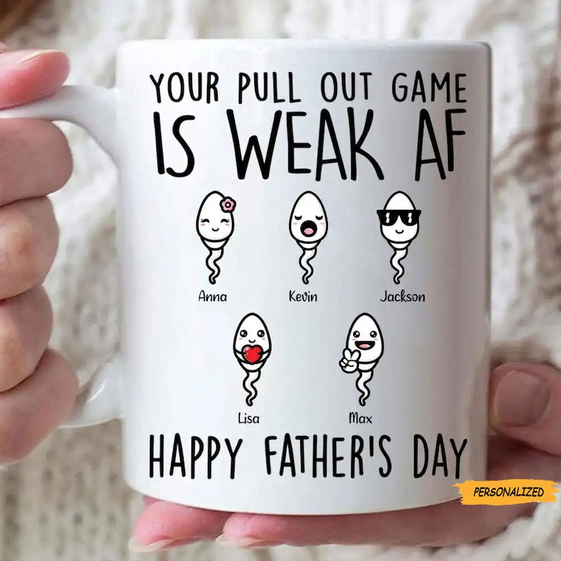 May include: White ceramic mug with the text "YOUR PULL OUT GAME IS WEAK AF" and "HAPPY FATHER'S DAY". The mug features cartoon sperm characters with names. The word "PERSONALIZED" is in a yellow box.