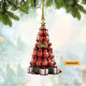May include: A red and gold Christmas tree ornament shaped like a Christmas tree made of boxing gloves. The tree is decorated with lights and presents. The name "David" is written on the tree. The ornament is personalized.
