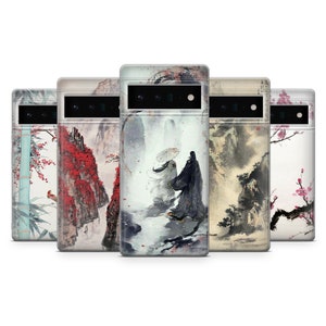 May include: Five different phone cases featuring a range of Asian-inspired designs. The designs include a bamboo forest, a mountain range, a couple walking through a misty forest, a mountain range with a river, and a branch of cherry blossoms.