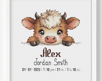 May include: A framed cross-stitch featuring a cartoon cow with brown and cream fur. The cow's name, "Alex Jordan Smith," is below, along with birth details: 01-01-2022, 7:10 pm, 21 inches, 1 lb. 10 oz. The artwork is set against a white background.