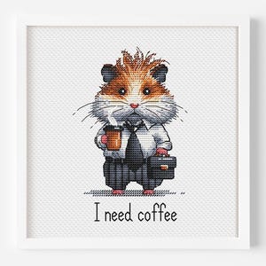 May include: Cross-stitch art of a hamster in a suit, holding a coffee cup and briefcase. The hamster has brown and white fur and is wearing a white shirt, black tie, and gray suit pants. The text "I need coffee" is below the hamster.