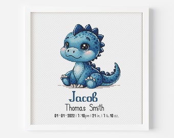 May include: A framed cross-stitch featuring a blue cartoon dinosaur. The dinosaur is sitting and has large eyes. The text below the dinosaur reads "Jacob Thomas Smith" with the date, time, height (21 in), and weight (7 lbs 10 oz).