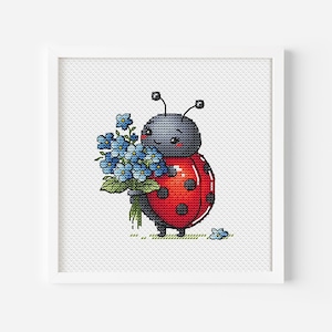 May include: A red and black ladybug with a white face and black eyes holds a bouquet of blue forget-me-not flowers. The ladybug is standing on a green patch of grass.