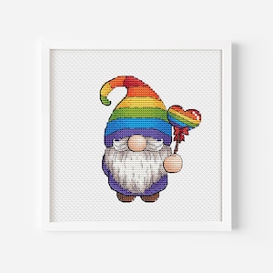 May include: A rainbow gnome with a white beard holding a heart-shaped lollipop. The gnome is wearing a purple hat with a rainbow stripe pattern.