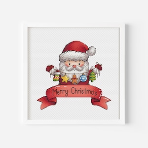 Pode incluir: Padrão de ponto cruz com um Papai Noel de desenho animado segurando enfeites de Natal e uma faixa que diz "Feliz Natal".