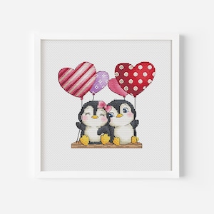 May include: Two penguins holding heart-shaped balloons. The balloons are red with white polka dots, pink with white stripes, and purple. The penguins are sitting on a wooden platform.