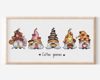 May include: Five gnomes wearing different colored hats with coffee cup and pastry designs. The gnomes are lined up in a row and the text "Coffee gnomes" is below them.