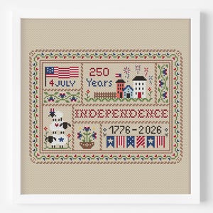 May include: Cross-stitch artwork in a white frame, celebrating 250 years of Independence. Features an American flag, fireworks, houses, and the text "INDEPENDENCE 1776-2026". Includes a border with floral and geometric patterns.
