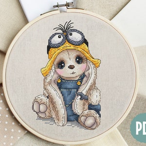 K&ouml;nnte beinhalten: Kreuzstichmuster eines niedlichen Kaninchens, das ein gelbes und schwarzes Minion-Kost&uuml;m mit Schutzbrille tr&auml;gt. Das Kaninchen sitzt mit gekreuzten Pfoten und hat einen s&uuml;&szlig;en Gesichtsausdruck.