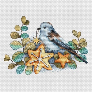 May include: A blue bird with brown wings sits on a branch with green leaves and two yellow star-shaped cookies. The bird is holding a gold star in its beak.