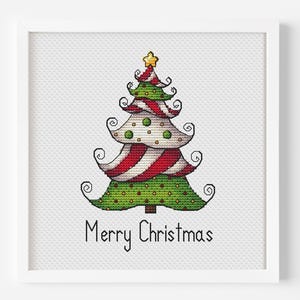 May include: A framed cross-stitch embroidery featuring a stylised Christmas tree with alternating green and red-and-white striped sections, decorated with small dots and a yellow star on top, with the text Merry Christmas stitched below in black.