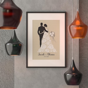 May include: A framed wedding announcement with a silhouette of a bride and groom. The bride is wearing a gown with floral details. The text reads "Jacob & Olivia 01.01.2024".