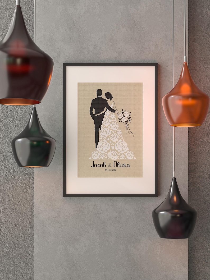 May include: A framed wedding announcement with a silhouette of a bride and groom. The bride is wearing a gown with floral details. The text reads "Jacob & Olivia 01.01.2024".