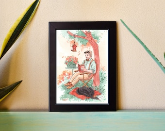 May include: Framed watercolor print depicting a person reading a book under a tree. The illustration features a person in a chair, a dog, a bird feeder, and flowers. The artwork is set in a garden with a black frame.