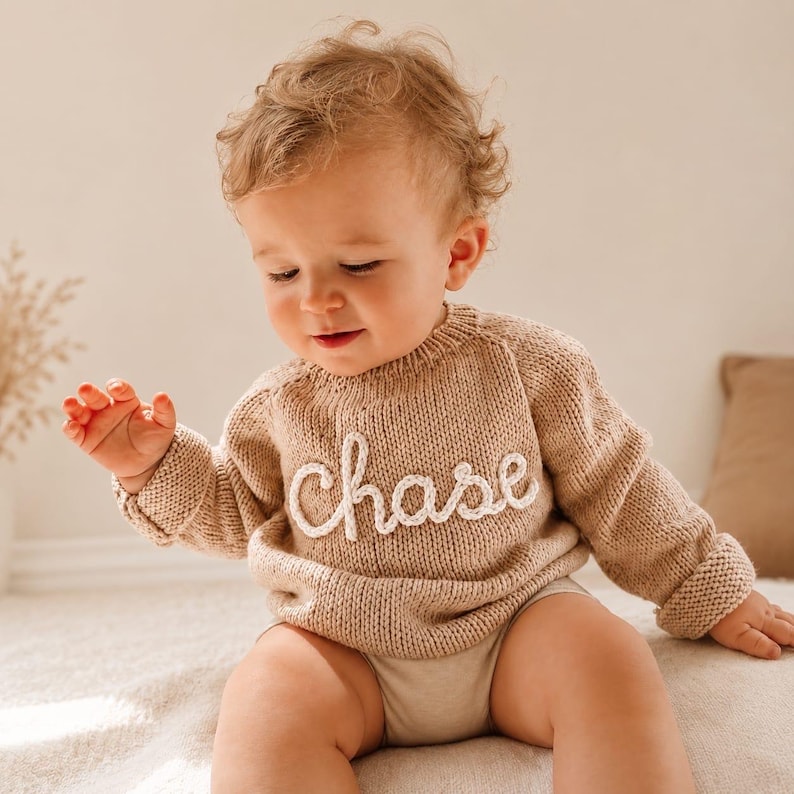 Beige personalized baby name sweater with custom knitted name “Chase”. Handmade knit baby jumper for newborns and toddlers, custom baby shower gift, neutral baby clothing.