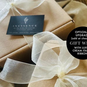 a gift wrap with a white ribbon on it