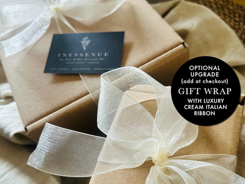 a gift wrap with a white ribbon on it