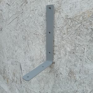 May include: A grey metal L-shaped shelf bracket with four holes for mounting.