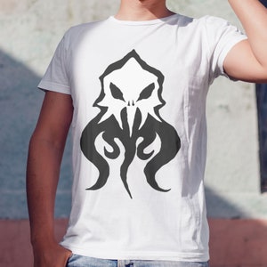 May include: White t-shirt with a black and white graphic print of a stylized octopus with a skull-like face.