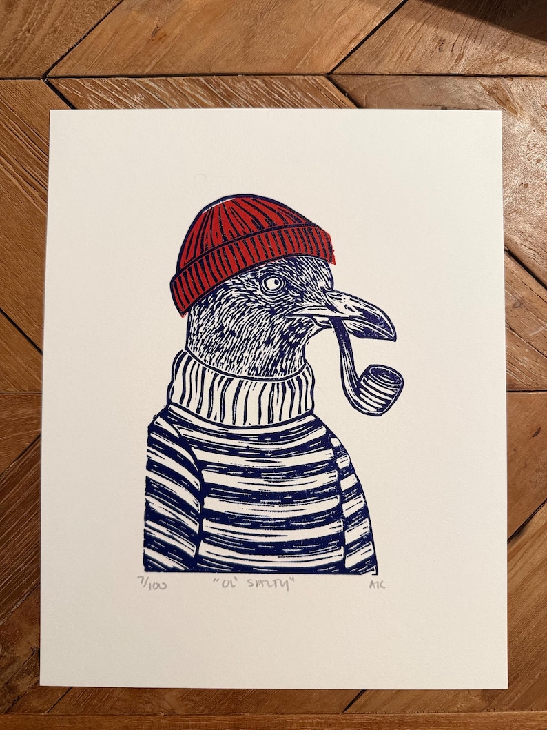 May include: A print of a bird wearing a red beanie, striped sweater, and smoking a pipe. The bird is blue and white, with the text "Ol' Smith" and the edition number 1/100 at the bottom.