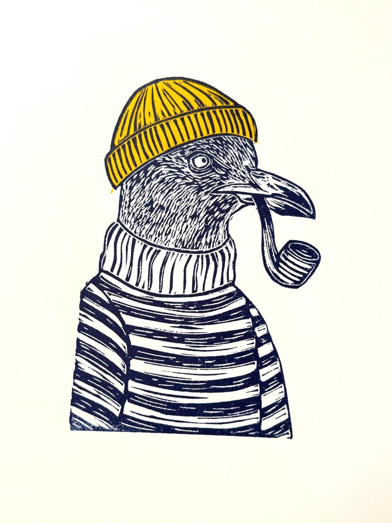 May include: A black and white linocut print of a bird wearing a yellow beanie, striped sweater, and smoking a pipe. The bird has a detailed, textured appearance, with a nautical theme. The print is on a white background.