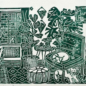 May include: A green and white linocut print depicting a room with plants, a chair, and a dog. The print features a window, a potted plant, a side table, and a chair with a dog sleeping on it. The text "Plant Power" is visible on a sign in the top right corner of the print.