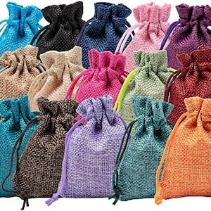 May include: A collection of 15 small burlap drawstring bags in various colors, including blue, green, purple, pink, red, and brown. The bags are made of natural burlap fabric and have a drawstring closure.