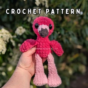 May include: A crochet flamingo plush toy with bright pink yarn, a dark grey beak, and large black safety eyes. The text CROCHET PATTERN is displayed at the top, and the watermark @HANDMADEBYNIKELLE is visible on the flamingo's chest.