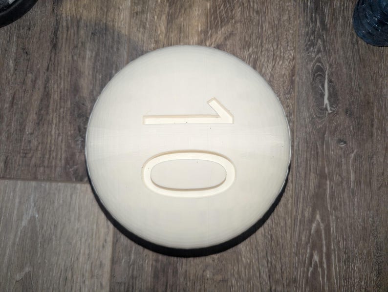 May include: A white round disc with the number "10" embossed on it.