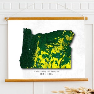 May include: A white canvas print with a green and yellow map of Oregon. The map is titled "University of Oregon" and "OREGON".