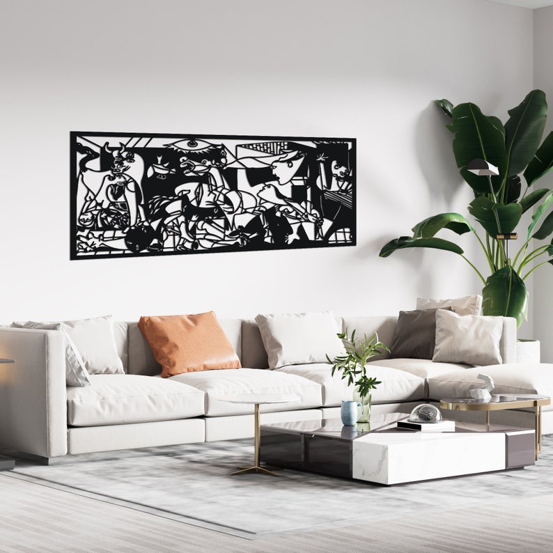 May include: Black and white wall art featuring a stylized depiction of a famous painting. The art is displayed above a white couch with pillows and a coffee table.