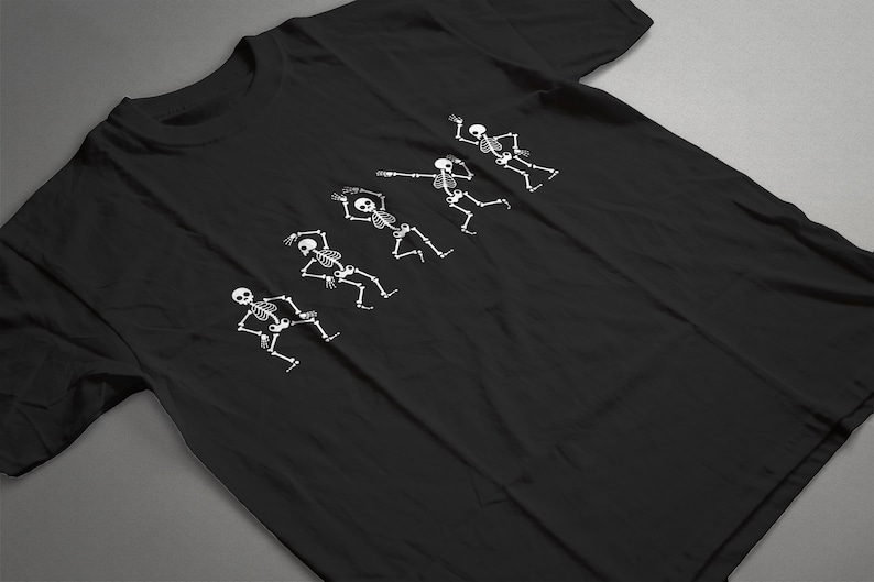 May include: Black t-shirt with a white graphic of five skeletons dancing. The skeletons are in different poses, with their arms and legs outstretched.