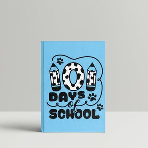 May include: A blue notebook with a black and white illustration of a number "101" with paw prints and pencils. The text "Days of School" is written in black below the number.