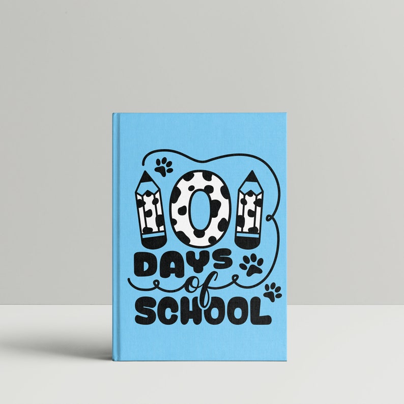May include: A blue notebook with a black and white illustration of a number "101" with paw prints and pencils. The text "Days of School" is written in black below the number.