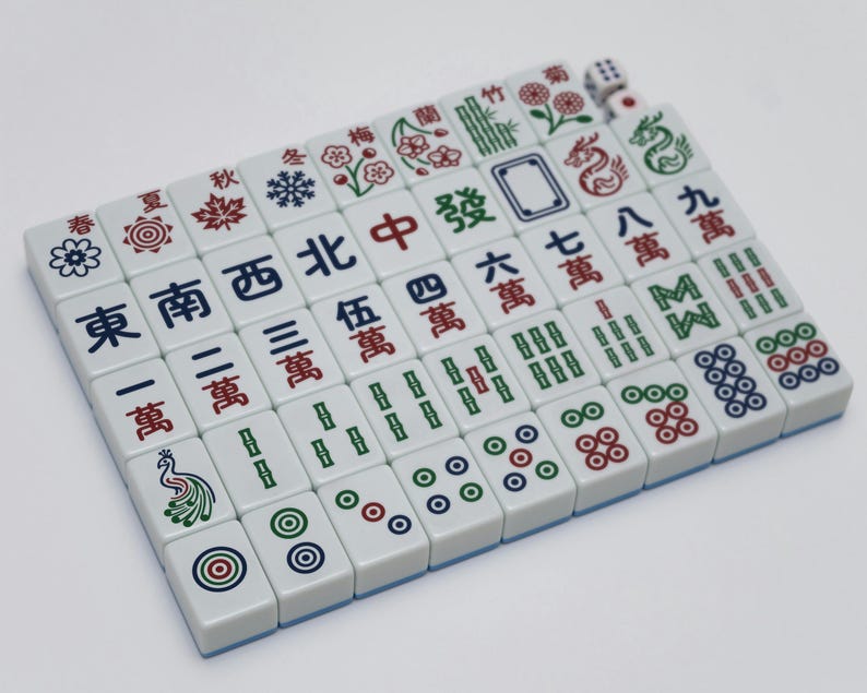 May include: A complete set of white Mahjong tiles with blue edges, featuring Chinese characters and symbols in red, green, and black. Includes dice. A classic board game.