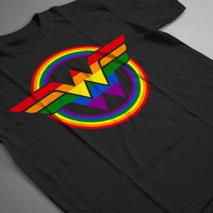 May include: Black t-shirt featuring a rainbow Wonder Woman logo. The logo is a stylised 'W' with a rainbow circle around it.