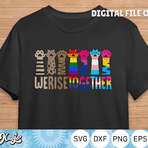 May include: Black t-shirt with a graphic of paw prints in different colors, including rainbow, black, brown, and white. The text "We Rise Together" is printed below the paw prints.