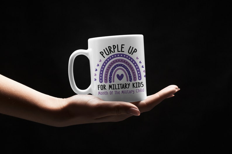 May include: White ceramic mug with a purple rainbow design and the text "Purple Up for Military Kids" and "Month of the Military Child".