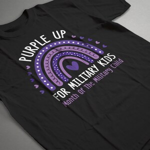 May include: Purple Up for Military Kids t-shirt featuring a rainbow design and the text "Month of the Military Child".
