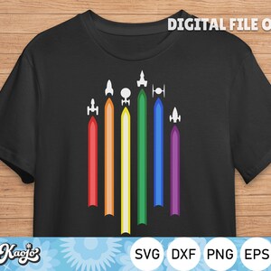 May include: A black t-shirt with a design of seven colorful rockets, each with a different color, representing the rainbow flag. The text "DIGITAL FILE ONLY" is at the top of the image.