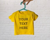 Personalised 100% cotton unisex yellow toddler T-shirt. Multiple fonts available.