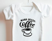 White 100% cotton baby vest with "Mama needs a coffee" design.