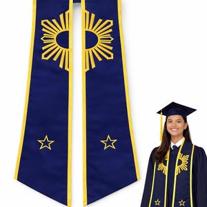 May include: A navy blue graduation stole with yellow trim and embroidered sunburst and star designs. The stole is displayed with a matching graduation gown and cap, creating a cohesive academic ensemble.